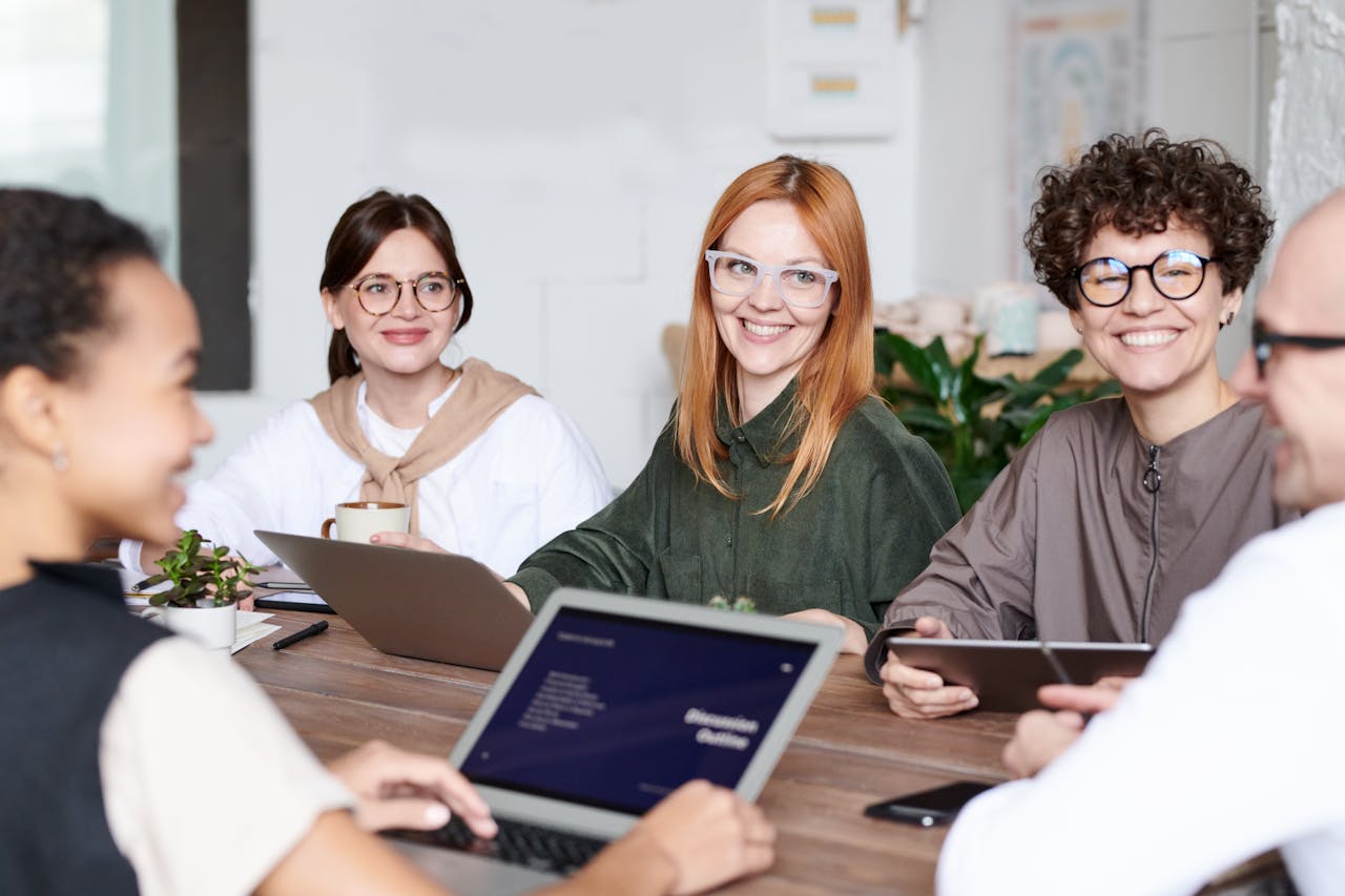 Diverse group of professionals collaborating in an office setting, focusing on teamwork and innovation.